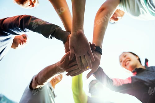 Preview: Team members' hands all in the center