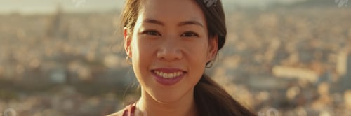 Preview: Close-up of young smiling woman looking at the camera while standing on viewing platform. Panoramic