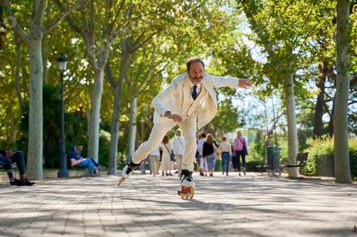 Preview: Man roller skating dynamically in a park with people in the background