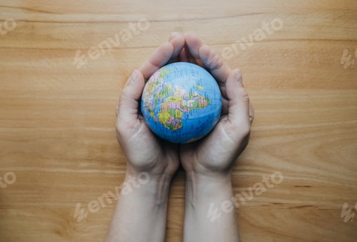 Preview: Globe in woman hands, top view