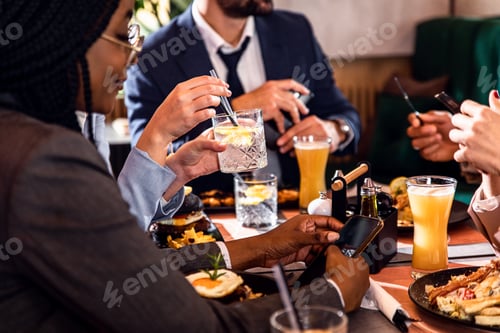 Preview: Hands of business people sitting in a restaurant at a business lunch.