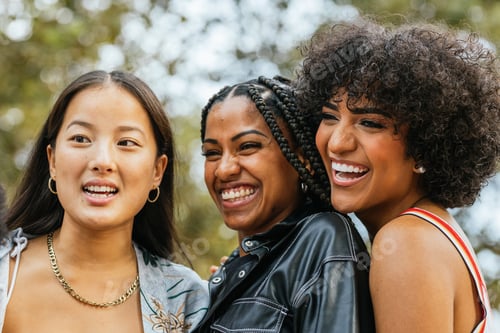 Preview: Three Friends Smiling and Laughing Together Outdoors