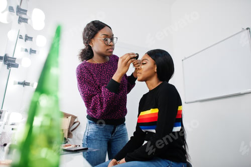 Preview: African American woman applying make-up