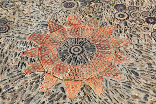 Preview: Patterned floor with pattern from pebbles bricks and gears