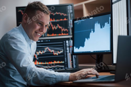Preview: Man working online in the office with multiple computer screens in index charts