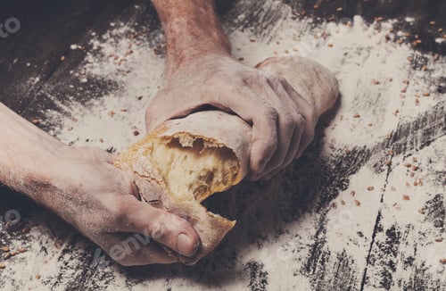 Preview: Bakery concept background. Hands breaking bread loaf