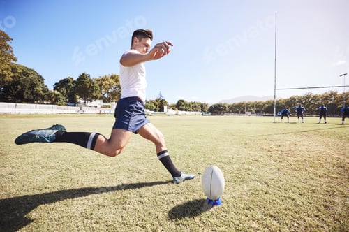 Preview: One caucasian rugby player kicking off during a rugby match outside on the field. Young athletic ma