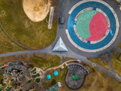 Preview: Aerial top view over an empty park with different ball courts for sports and playground areas