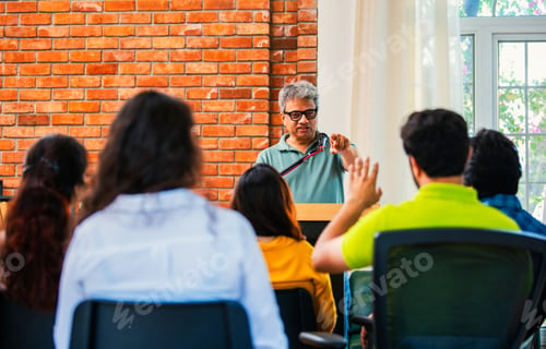 Preview: Indian Asian Confident life coach addressing entrepreneurs at a business event with a microphone