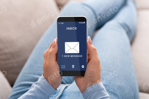 Preview: Woman Reading E-Mail Message On Smartphone Sitting On Couch Indoor