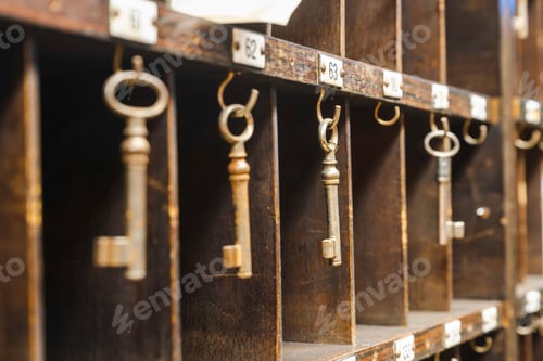 Preview: Collection of old keys hanging on wooden shelves in a room