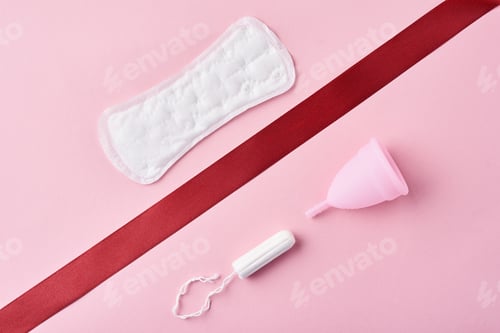 Preview: Sanitary pad, menstrual cup and tampon on a pink background