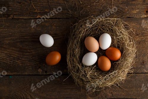 Preview: Fresh chicken eggs in a nest on a wooden background