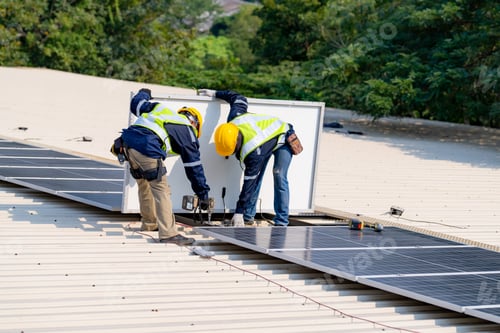 Preview: workers installing solar panels, for efficient energy on rooftop