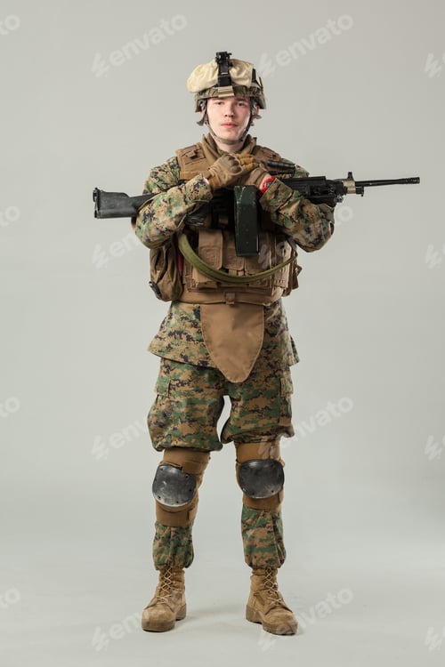 Preview: Soldier stands with weapon in uniform against plain background during training session