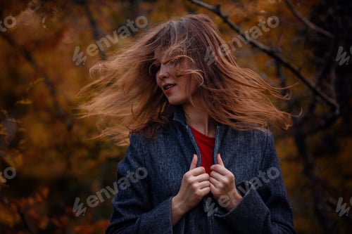 Preview: asian girl in coat enjoy autumn forest