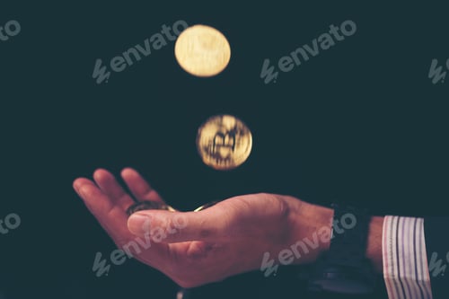 Preview: Golden Bitcoin in a man hand, Digitall symbol of a new virtual currency