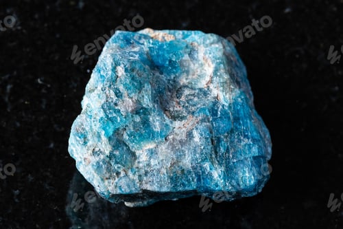 Preview: sample of rough blue apatite rock on black granite