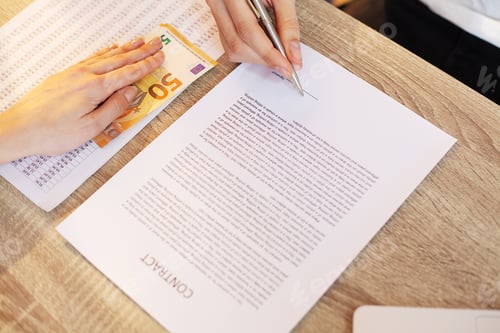 Preview: Businessman giving money while making deal to agreement a real estate contract