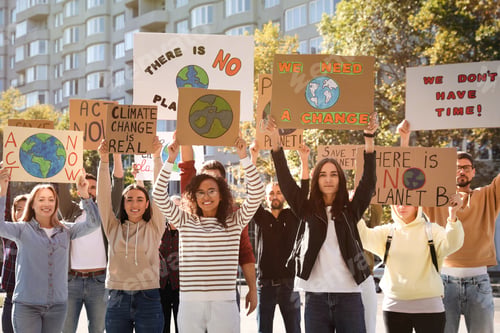 Preview: Group of people with posters protesting against climate change on city street