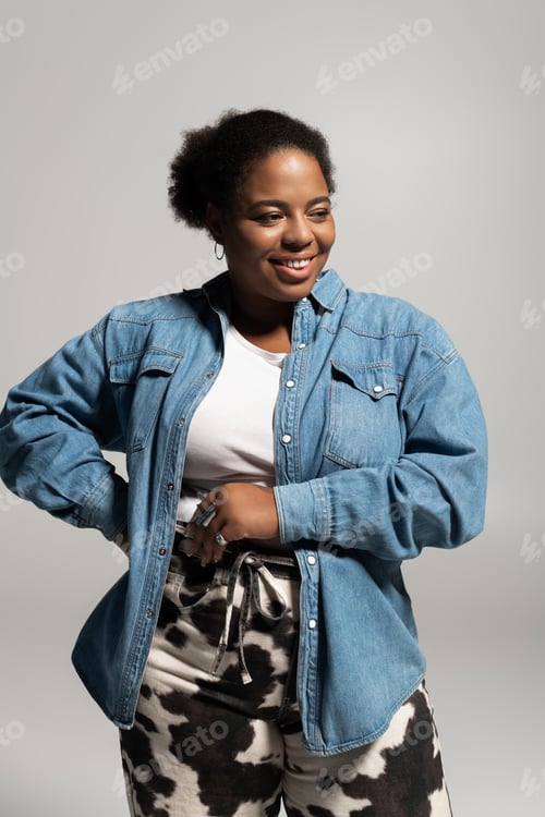 Preview: Stylish plus size woman showcases trendy autumn fashion in a modern studio setting