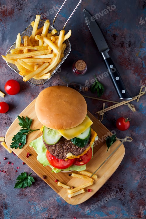 Preview: Hamburger with french fries, beer on a stone table
