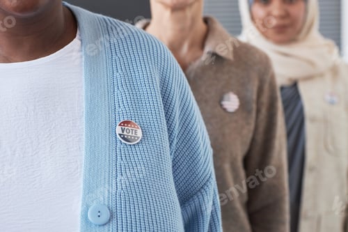 Preview: Close-up of young African American woman with vote badge on chest
