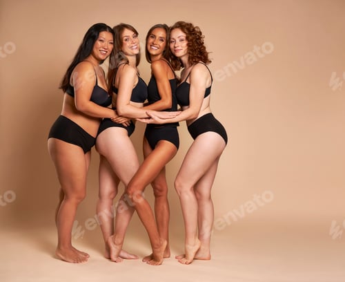 Preview: Group of four women in black underwear standing together and smiling towards the camera