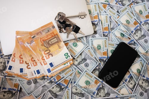 Preview: Dollar money with euro, keys, laptop and phone background.