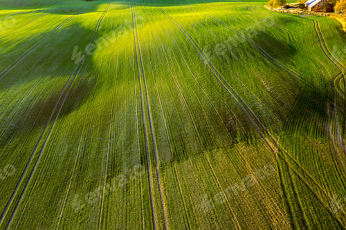 Preview: Picturesque autumn scene of a rolling hills of agricultural area from a birds eye view at sunset
