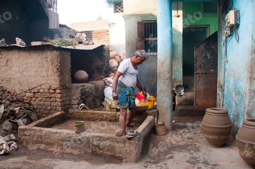 Preview: Potter preparing clay for making pots, India.