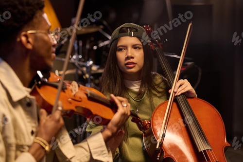 Preview: Hispanic Girl Playing Cello with Young Adult Black Man Playing Violin