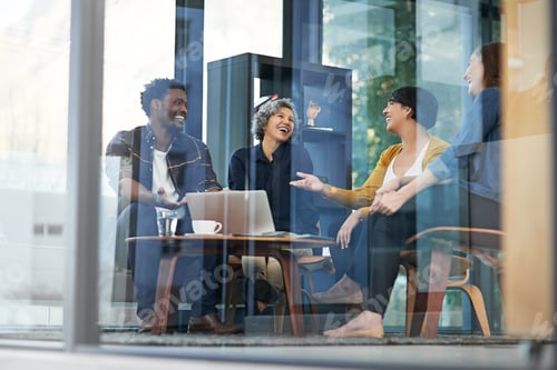 Preview: Shot of a team of creative businesspeople brainstorming around a laptop in the office