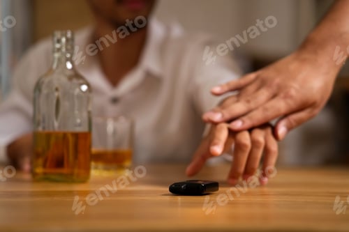 Preview: The drunk man sitting in restaurant trying to grab the car key after he drank a lot of whiskey.