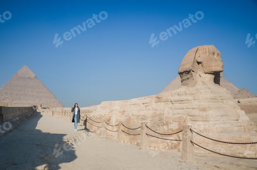 Preview: A European blonde walks near the pyramids in the desert in Cairo