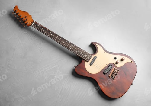 Preview: Modern electric guitar on color background, top view