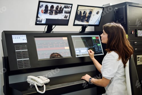 Preview: Nurse supervising hyperbaric oxygen therapy process from in control room.