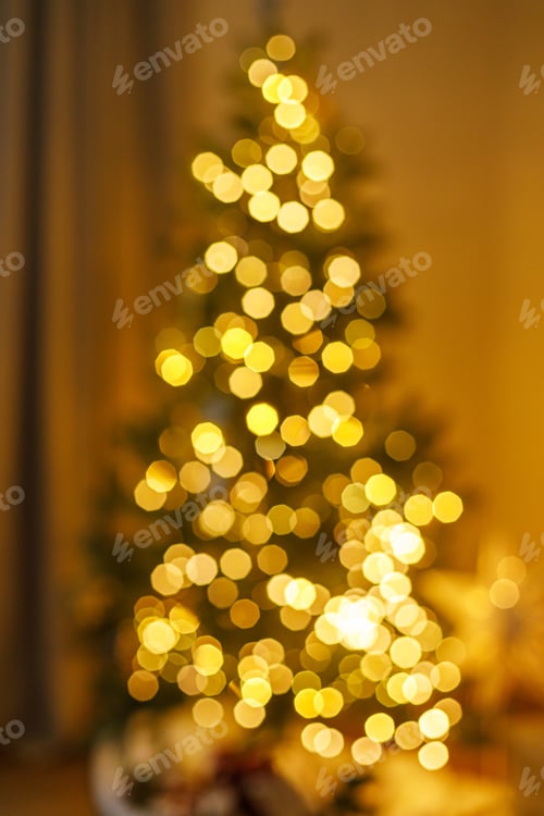 Preview: Xmas background. Blurred image of stylish christmas tree with golden lights bokeh