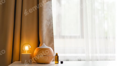 Preview: Aromatherapy concept. Aroma oil diffuser on the table against the window.