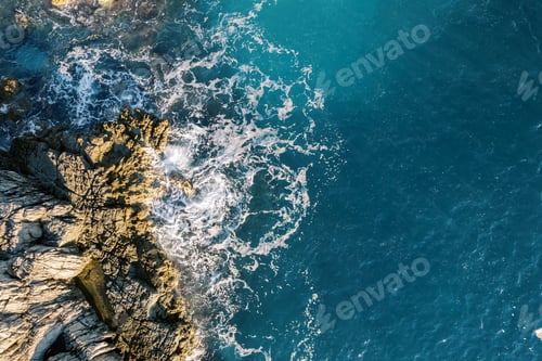 Preview: Sea waves crash against a rocky cliff. Drone