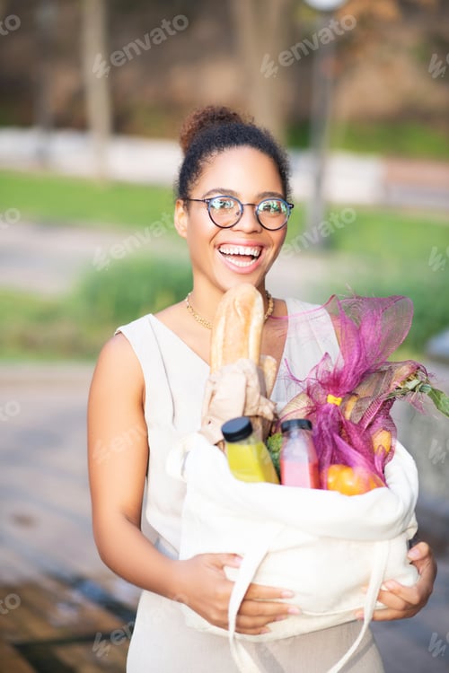 Preview: Positive excited woman coming back home from supermarket