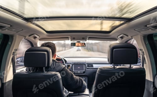 Preview: A male driver drives at speed through the streets of the city.