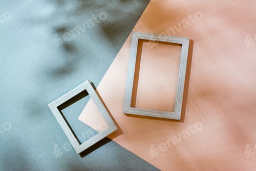 Preview: cardboard and blank photo frames in soft shadows from the leaves.