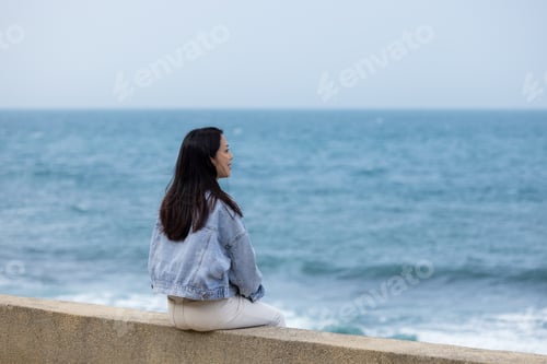 Preview: Woman sit beside the sea beach
