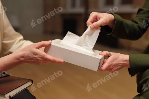 Preview: Young female taking paper handkerchief out of box