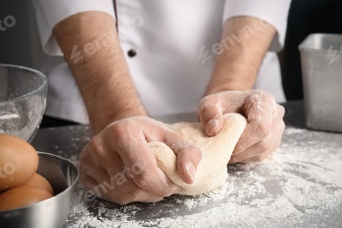 Preview: Man kneading dough for pastry on table