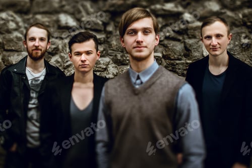 Preview: stylish handsome group of confident and successful men standing on the background of city street