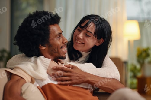 Preview: Young cheerful woman embracing husband
