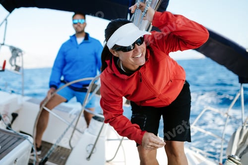 Preview: Attractive strong woman sailing with her boat