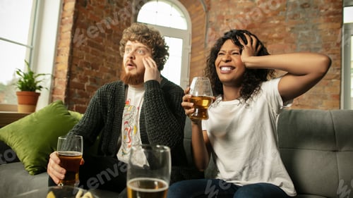 Preview: Excited couple, friends watching sport match, championship at home